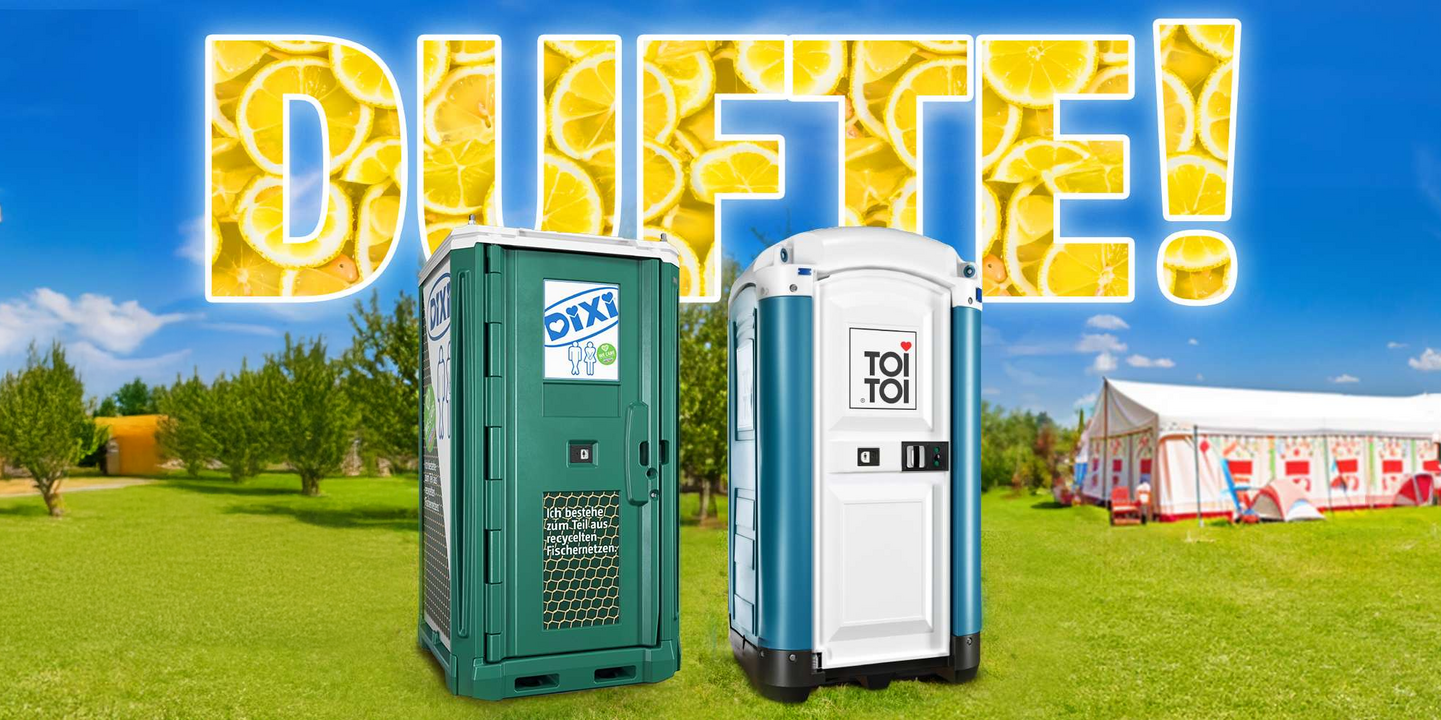 Toilettenkabinen auf grüner Wiese mit Duftspray